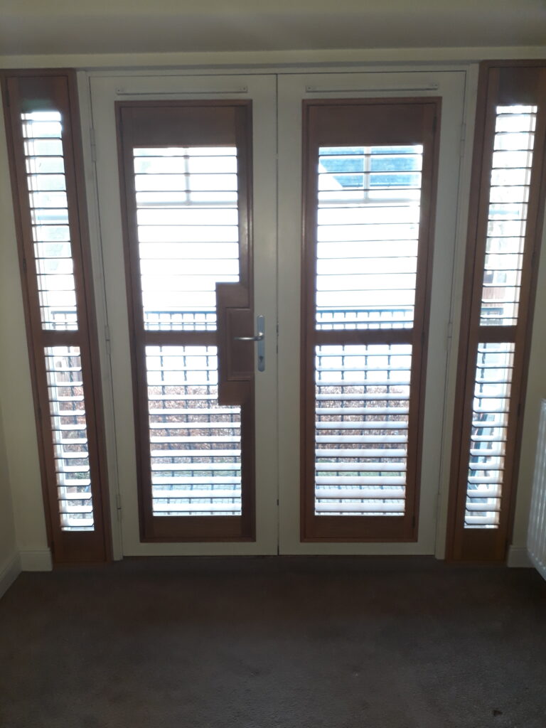 Window Shutters with a French Door Cutout for the Door Handle