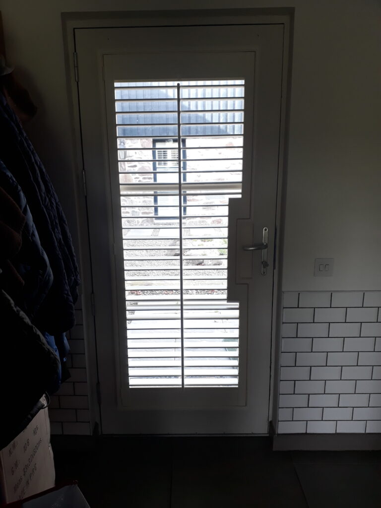 Window Shutters with a French Door Cutout for the Door Handle