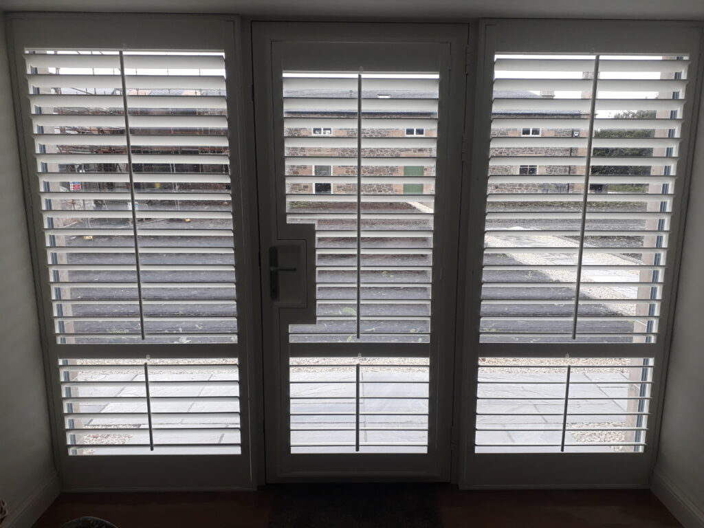 Window Shutters with a French Door Cutout for the Door Handle