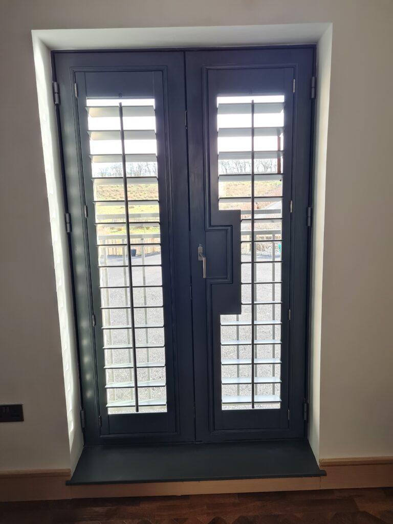 Window Shutters with a French Door Cutout for the Door Handle