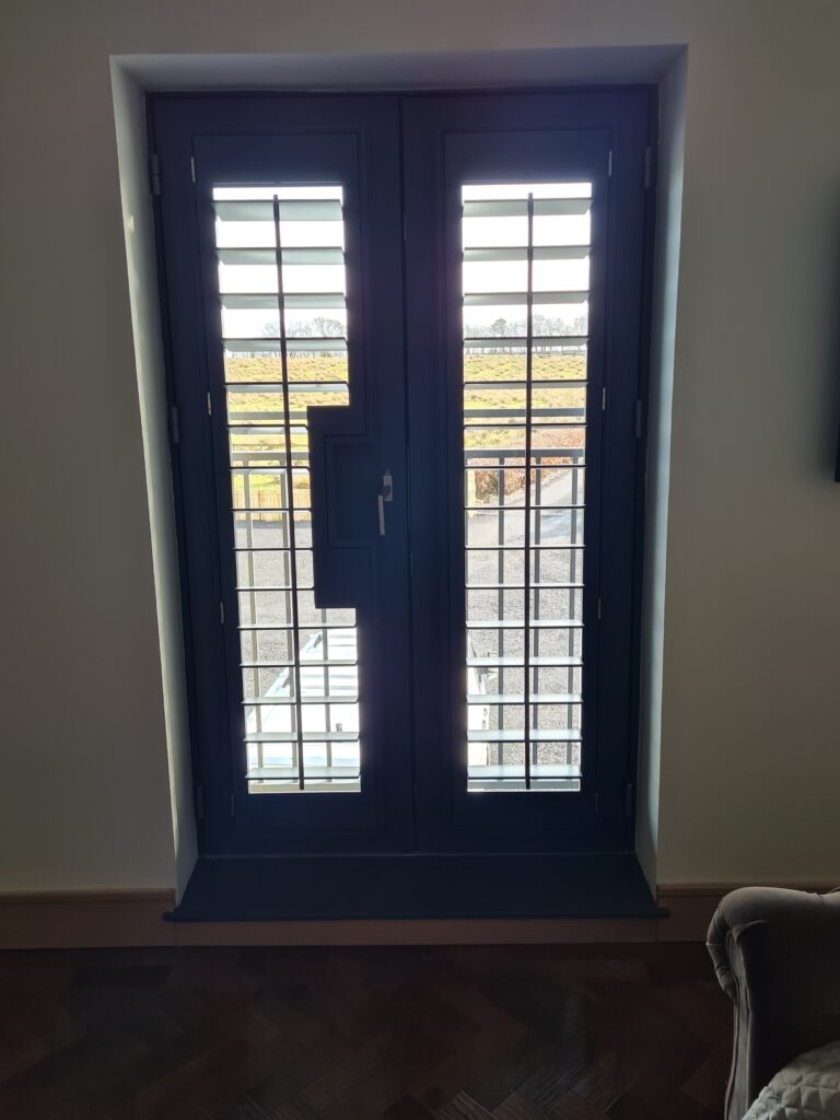 Window Shutters with a French Door Cutout for the Door Handle