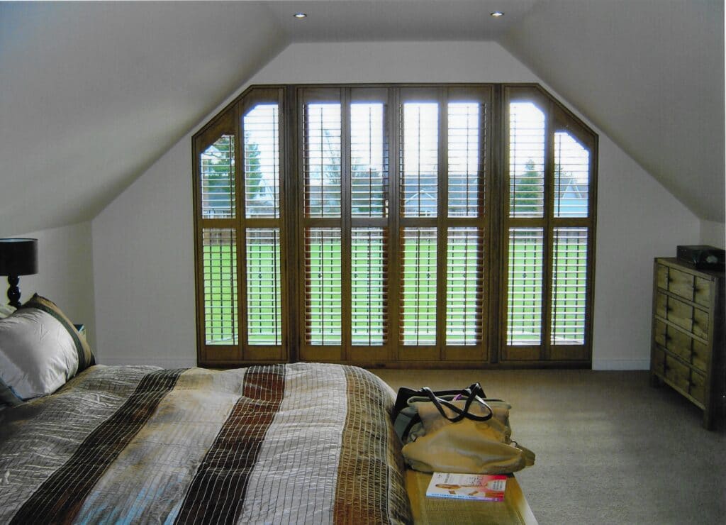 Shaped Shutters in a Bedroom from The Scottish Shutter Company