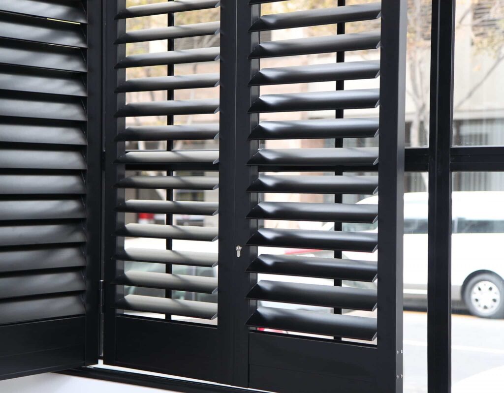 Aluminium Security Shutters  with 89mm louvres and finished in Charcoal