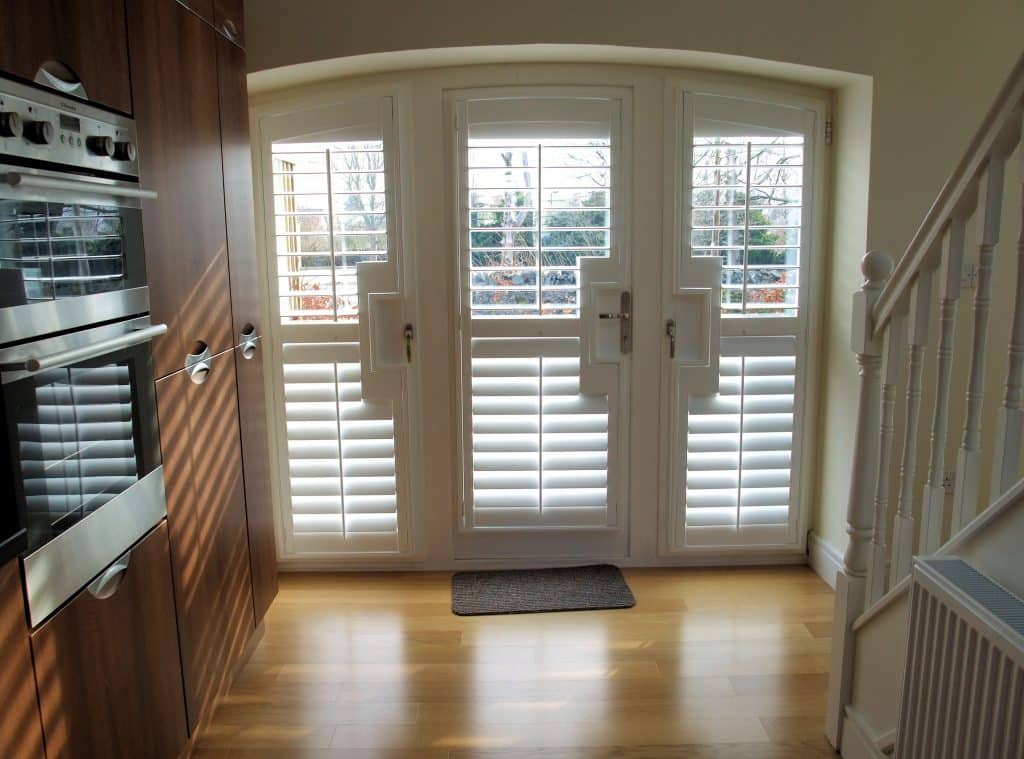 Window Shutters with a French Door Cutout for the Door Handle
