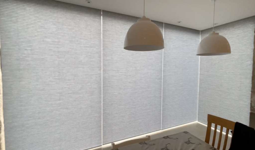 Translucent motorised Luxaflex Duette blinds on a large picture window