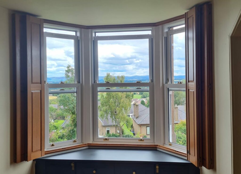Solid Window Shutters Wrapped Back on a Bay Window - by The Scottish Shutter Company