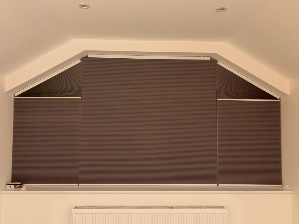 Motorised, Cellular, Room Darkening blinds on a flat top gable window - by Sona