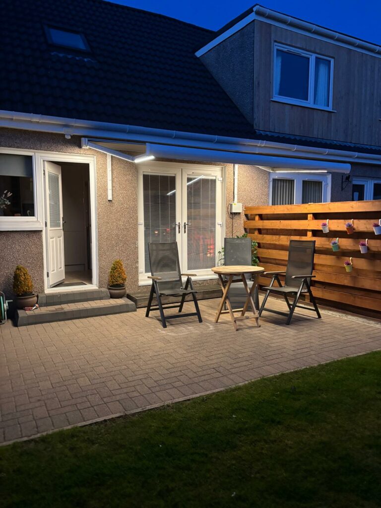 Patio Awning at Night with Arm Lights
